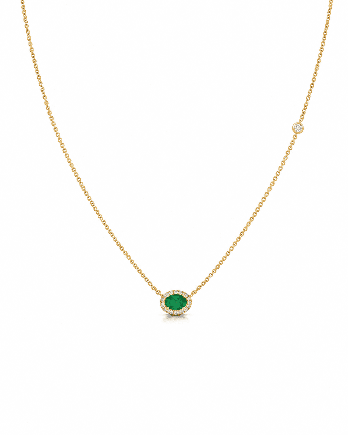 Gold necklace with a green gemstone and diamond centerpiece