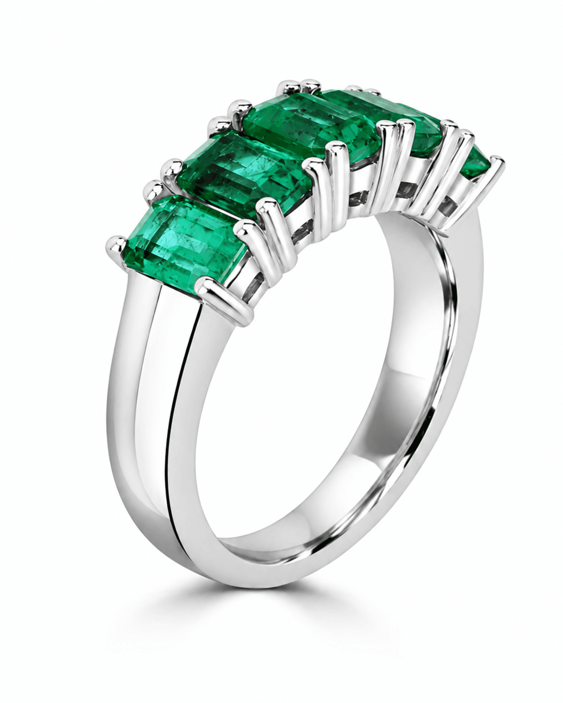 White-metal ring with emerald-cut green gemstones