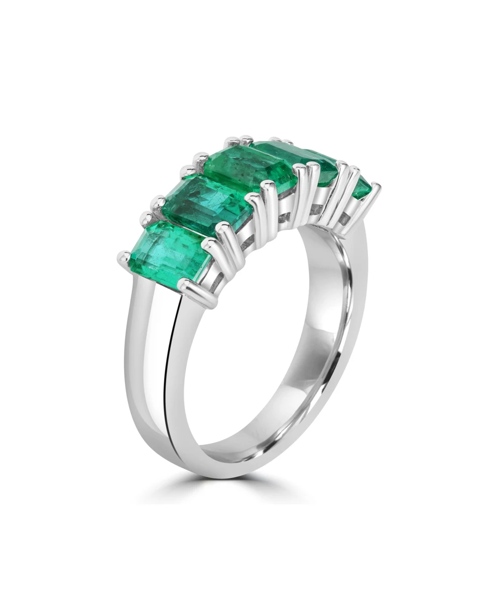 White-metal ring with emerald-cut green gemstones